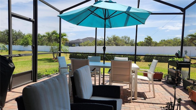 sunroom featuring outdoor dining space