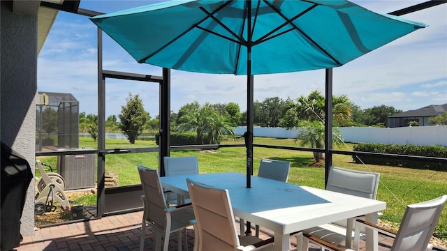 sunroom / solarium featuring outdoor dining area and plenty of natural light