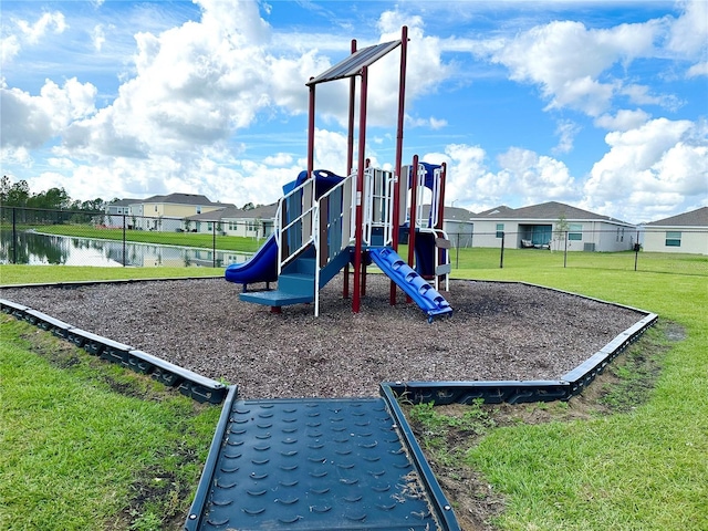 communal playground with a yard, a water view, fence, and a residential view
