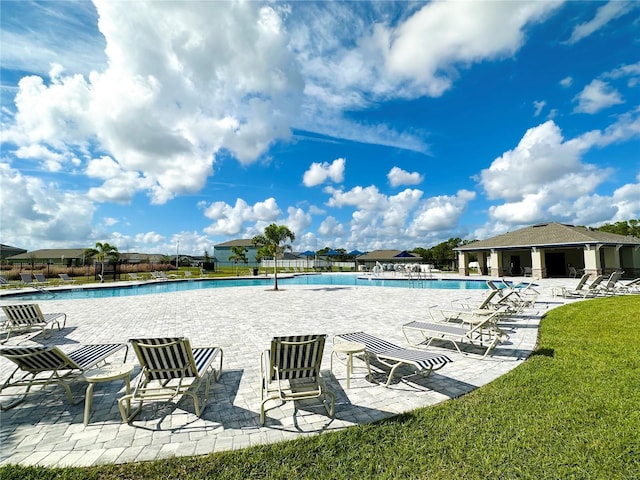 community pool featuring a patio area and fence