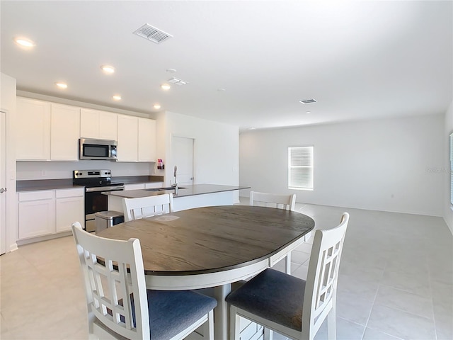 dining room featuring recessed lighting and light tile patterned floors