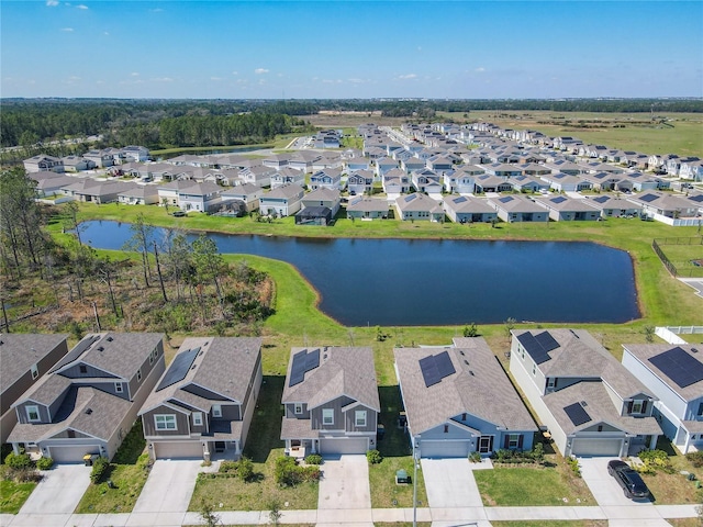 aerial view of residential area featuring a large body of water