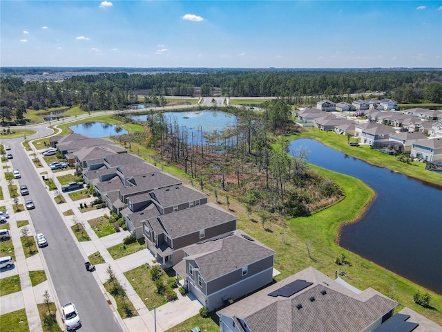 aerial view of residential area featuring a large body of water