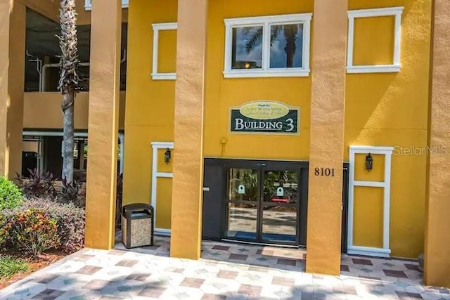8101 Resort Village Dr Unit 31501, Orlando, FL 32821 - doorway to property with stucco siding and french doors