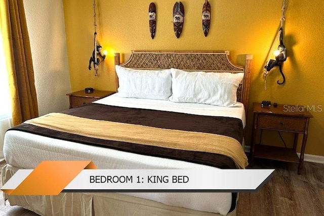8101 Resort Village Dr Unit 31501, Orlando, FL 32821 - bedroom featuring a textured wall, baseboards, and wood finished floors