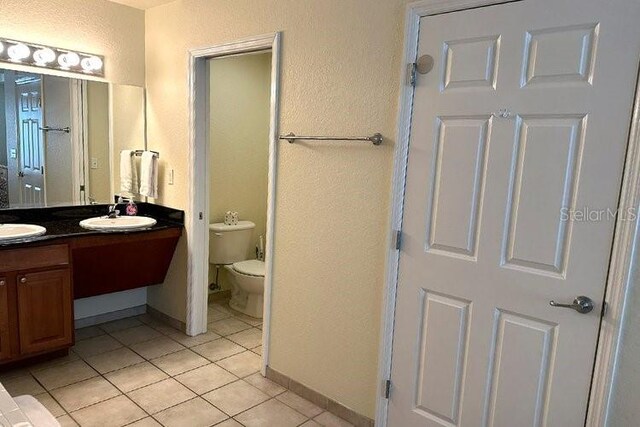 8101 Resort Village Dr Unit 31501, Orlando, FL 32821 - bathroom featuring a sink, double vanity, toilet, and tile patterned floors