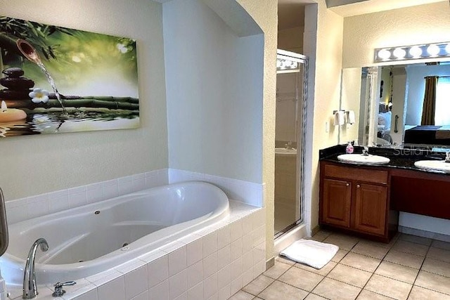 8101 Resort Village Dr Unit 31501, Orlando, FL 32821 - full bathroom featuring a stall shower, double vanity, a sink, and a whirlpool tub
