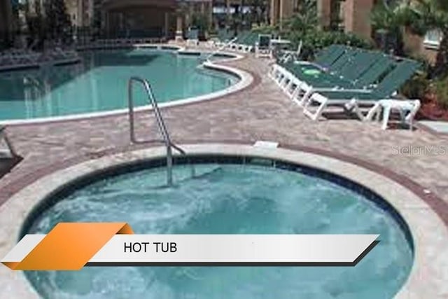 8101 Resort Village Dr Unit 31501, Orlando, FL 32821 - community pool featuring a patio and a community hot tub