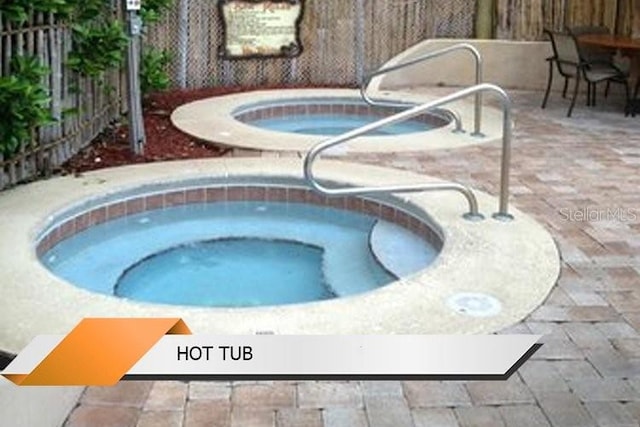 8101 Resort Village Dr Unit 31501, Orlando, FL 32821 - view of pool with an in ground hot tub, fence, and a patio area