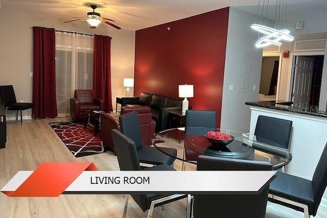 8125 Resort Village Dr Unit 51201, Orlando, FL 32821 - dining room featuring ceiling fan with notable chandelier and wood finished floors