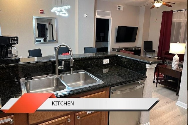 8125 Resort Village Dr Unit 51201, Orlando, FL 32821 - kitchen featuring a sink, brown cabinetry, visible vents, dishwasher, and a ceiling fan