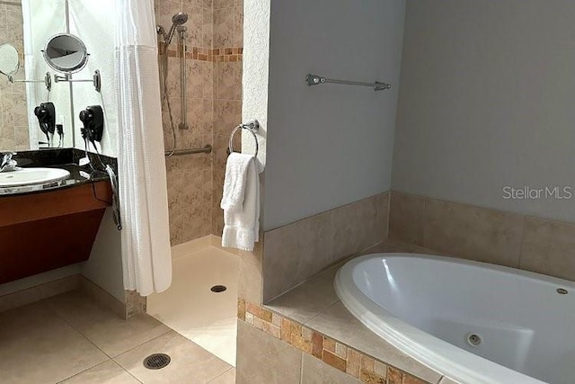 8125 Resort Village Dr Unit 51201, Orlando, FL 32821 - bathroom featuring a stall shower, tile patterned flooring, a garden tub, and vanity