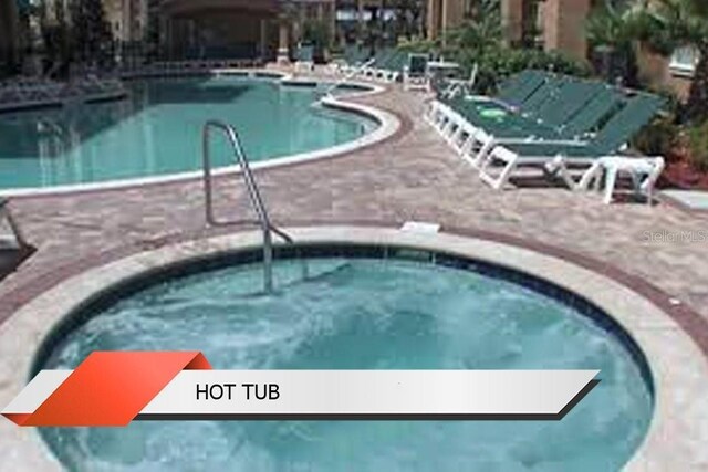 8125 Resort Village Dr Unit 51201, Orlando, FL 32821 - community pool featuring a hot tub and a patio area