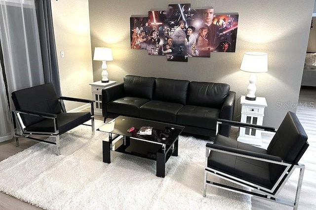 8112 Poinciana Blvd Unit 1502, Orlando, FL 32821 - living room with baseboards, a textured wall, and wood finished floors