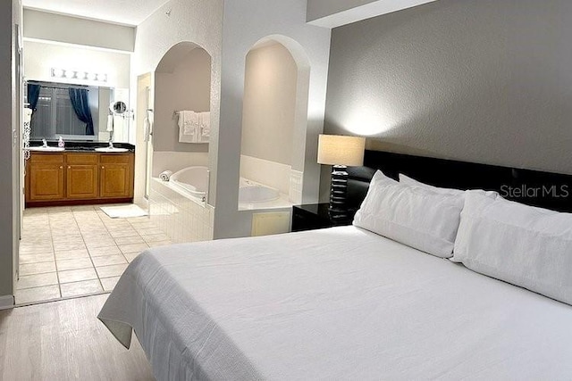8112 Poinciana Blvd Unit 1502, Orlando, FL 32821 - bedroom with ensuite bathroom and arched walkways