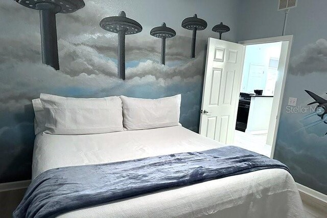 8112 Poinciana Blvd Unit 1502, Orlando, FL 32821 - bedroom with baseboards, visible vents, and wood finished floors