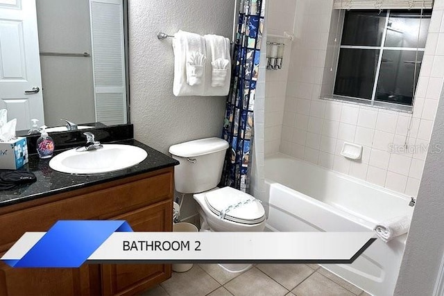 8112 Poinciana Blvd Unit 1502, Orlando, FL 32821 - full bathroom with toilet, tile patterned floors, a textured wall, shower / bathtub combination with curtain, and vanity