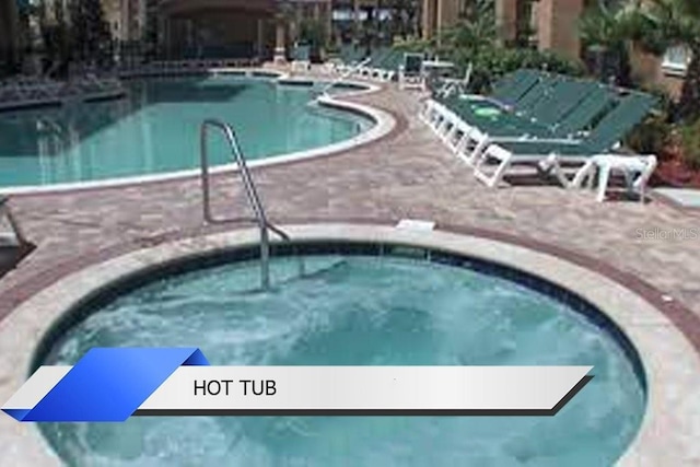 8112 Poinciana Blvd Unit 1502, Orlando, FL 32821 - pool featuring a hot tub and a patio area