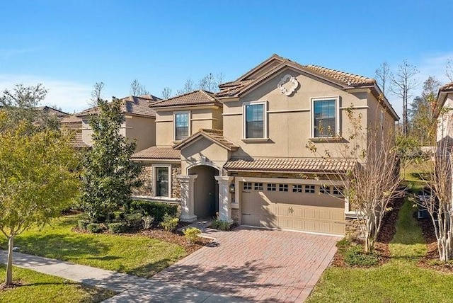 1466 Moon Valley Dr, Champions Gate, FL 33896 - view of front facade with a tiled roof, decorative driveway, an attached garage, stucco siding, and stone siding