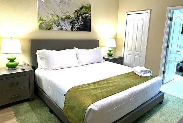 1466 Moon Valley Dr, Champions Gate, FL 33896 - bedroom featuring light wood finished floors and a closet