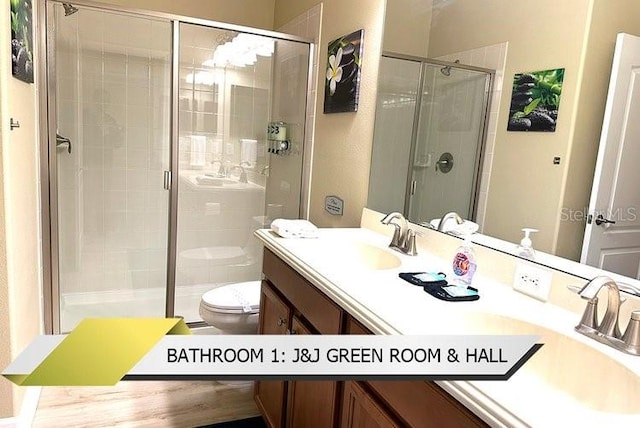 1466 Moon Valley Dr, Champions Gate, FL 33896 - bathroom featuring a stall shower, double vanity, toilet, and a sink