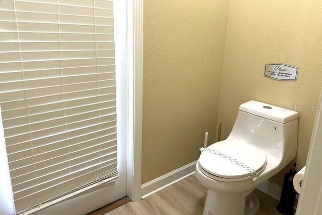 1466 Moon Valley Dr, Champions Gate, FL 33896 - bathroom featuring toilet, baseboards, and wood finished floors
