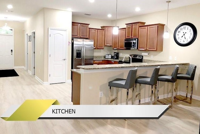 1466 Moon Valley Dr, Champions Gate, FL 33896 - kitchen featuring a peninsula, light wood-style floors, stainless steel appliances, and decorative light fixtures