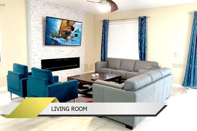 1466 Moon Valley Dr, Champions Gate, FL 33896 - living area with baseboards, wood finished floors, a fireplace, and ceiling fan