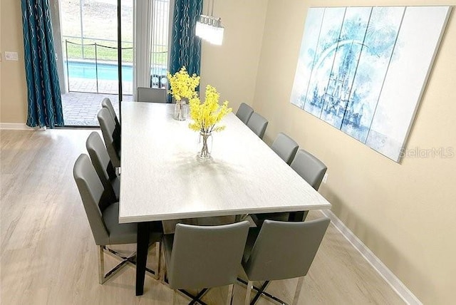 1466 Moon Valley Dr, Champions Gate, FL 33896 - dining space featuring baseboards and wood finished floors