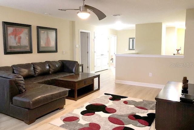 1466 Moon Valley Dr, Champions Gate, FL 33896 - living area featuring light wood-type flooring, baseboards, a ceiling fan, and visible vents