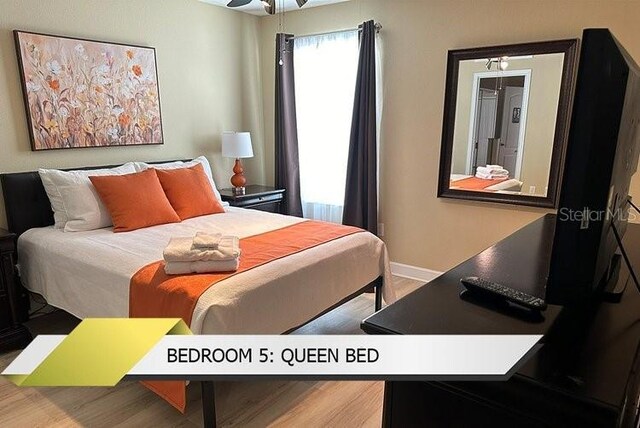 1466 Moon Valley Dr, Champions Gate, FL 33896 - bedroom featuring wood finished floors and baseboards