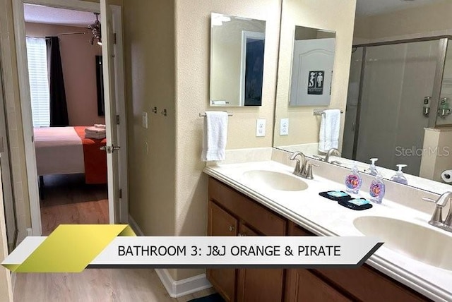 1466 Moon Valley Dr, Champions Gate, FL 33896 - bathroom with a shower stall, a sink, and wood finished floors