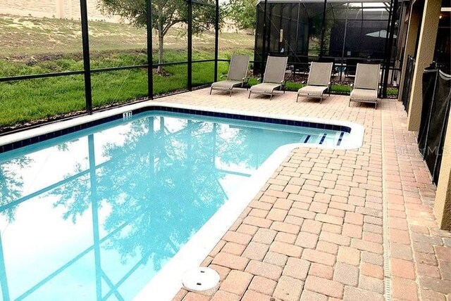 1466 Moon Valley Dr, Champions Gate, FL 33896 - outdoor pool with a patio area and a lanai