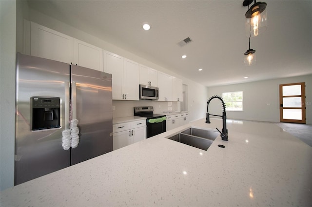 16600 SW 23rd Avenue Rd, Ocala, FL 34473 - kitchen featuring a sink, light stone countertops, visible vents, and appliances with stainless steel finishes