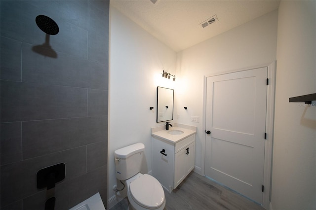 16600 SW 23rd Avenue Rd, Ocala, FL 34473 - bathroom with vanity, toilet, visible vents, and wood finished floors