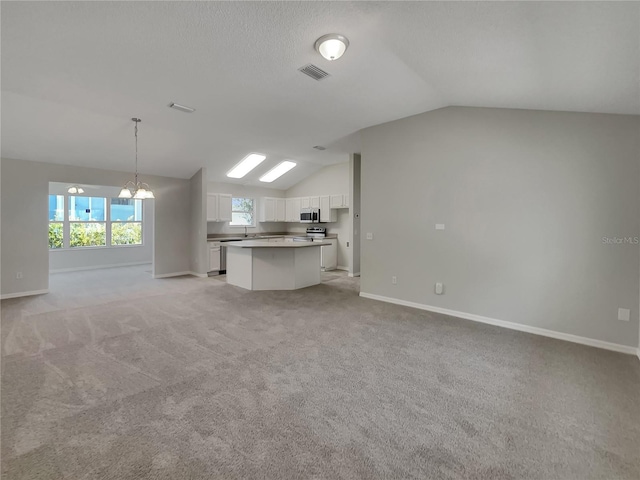 2708 La Posada Dr, The Villages, FL 32162 - unfurnished living room with vaulted ceiling, light colored carpet, baseboards, and visible vents