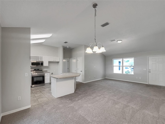 2708 La Posada Dr, The Villages, FL 32162 - kitchen featuring visible vents, white cabinetry, vaulted ceiling, stainless steel appliances, and light colored carpet