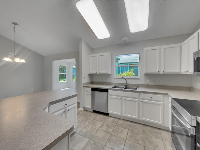 2708 La Posada Dr, The Villages, FL 32162 - kitchen with a sink, stainless steel appliances, light tile patterned floors, and white cabinets