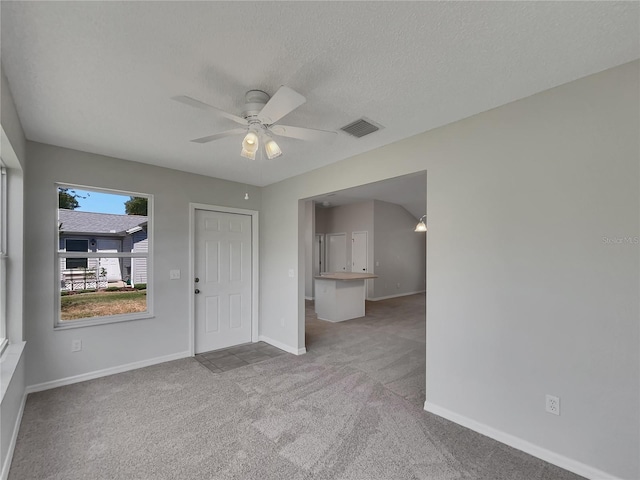 2708 La Posada Dr, The Villages, FL 32162 - spare room featuring a textured ceiling, baseboards, carpet flooring, ceiling fan, and visible vents