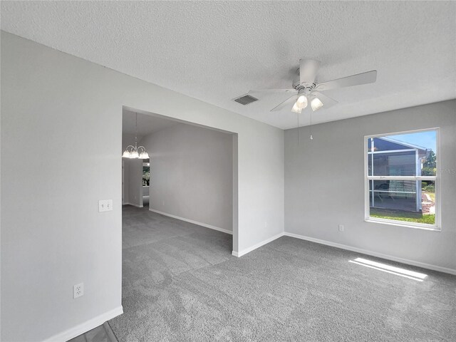 2708 La Posada Dr, The Villages, FL 32162 - carpeted empty room featuring a textured ceiling, ceiling fan with notable chandelier, baseboards, and visible vents