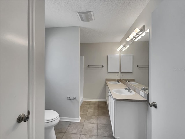 2708 La Posada Dr, The Villages, FL 32162 - bathroom featuring a textured ceiling, tile patterned floors, visible vents, and a sink
