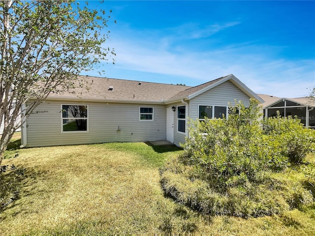 2708 La Posada Dr, The Villages, FL 32162 - rear view of house with a yard and a shingled roof
