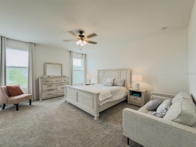 bedroom featuring light carpet and a ceiling fan