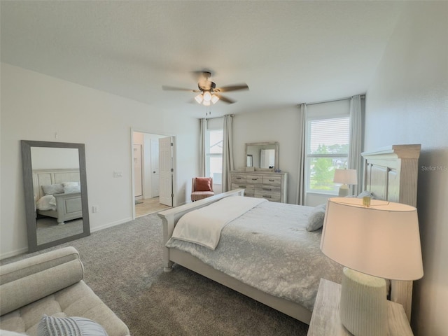 carpeted bedroom with baseboards and ceiling fan