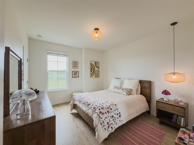 bedroom with wood finished floors and baseboards