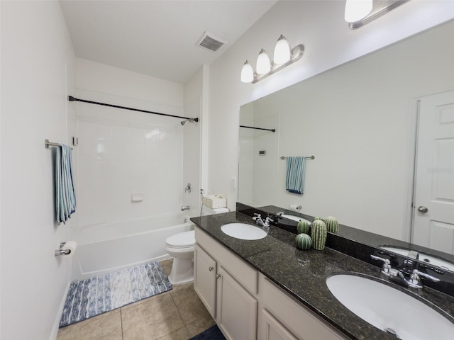 bathroom featuring toilet, tile patterned floors, double vanity, and bathtub / shower combination