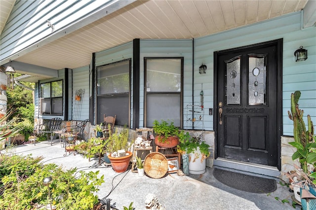 view of exterior entry with covered porch