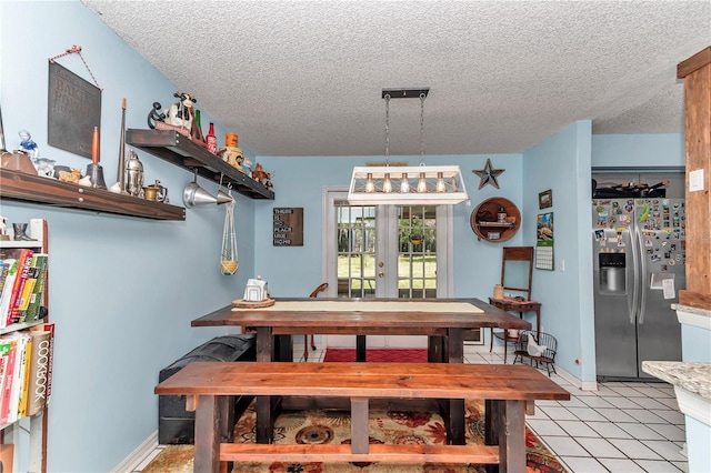 dining space with a textured ceiling and french doors