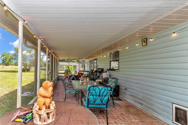 sunroom featuring outdoor dining space