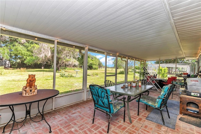 sunroom featuring outdoor dining space and plenty of natural light